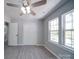 Bedroom featuring a ceiling fan, wood-look floors, and plenty of natural light at 600 Burns St, Wadesboro, NC 28170