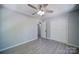 Bedroom with wood-look flooring, ceiling fan, and large closet at 600 Burns St, Wadesboro, NC 28170