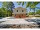 View of a two-story home featuring a brick facade and a large, circular driveway at 600 Burns St, Wadesboro, NC 28170