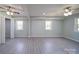 Expansive living room with modern gray flooring, neutral walls, and updated ceiling fans at 600 Burns St, Wadesboro, NC 28170