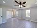 Open-concept living room featuring hardwood flooring, natural lighting, and ceiling fans at 600 Burns St, Wadesboro, NC 28170