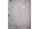 Close up of the shower featuring marble-look walls and a mosaic tile shower floor at 600 Burns St, Wadesboro, NC 28170