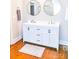 Bathroom with double sinks, modern fixtures, white cabinets and wood floors at 606 Childs St, Lincolnton, NC 28092