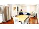 Dining area with stainless steel refrigerator, table and wood floors at 606 Childs St, Lincolnton, NC 28092
