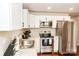 Modern kitchen with stainless steel appliances, granite counters and white cabinetry at 606 Childs St, Lincolnton, NC 28092