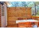 Outdoor patio featuring a wooden table, chairs, and privacy screen with string lights at 606 Childs St, Lincolnton, NC 28092