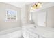 Bathroom with vanity, tub, and natural light at 6418 Castlewynd Ct, Charlotte, NC 28212