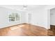 Bright bedroom with hardwood floors, white walls, and ceiling fan at 6418 Castlewynd Ct, Charlotte, NC 28212