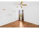 Bright bedroom featuring hardwood floors, a ceiling fan, and a window at 6418 Castlewynd Ct, Charlotte, NC 28212