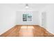 Sunlit bedroom with hardwood floors and a ceiling fan at 6418 Castlewynd Ct, Charlotte, NC 28212