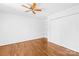 Bedroom with hardwood floors, ceiling fan and closet with built in shelving at 6418 Castlewynd Ct, Charlotte, NC 28212