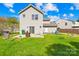 Back exterior featuring a grassy yard, sliding glass doors, and partial fencing at 6418 Castlewynd Ct, Charlotte, NC 28212