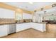 Bright kitchen features stainless steel appliances, white cabinets, and tile backsplash at 6418 Castlewynd Ct, Charlotte, NC 28212