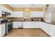 Functional kitchen with white cabinets, stainless steel appliances, and stylish tile backsplash at 6418 Castlewynd Ct, Charlotte, NC 28212