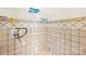 Tiled laundry room with storage shelves and utility hook-ups at 6418 Castlewynd Ct, Charlotte, NC 28212