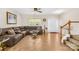 Spacious living room with tile floors, a comfortable sectional sofa, and staircase at 6418 Castlewynd Ct, Charlotte, NC 28212