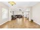 Inviting living room with tile floors, a staircase, and a view of the front entry at 6418 Castlewynd Ct, Charlotte, NC 28212