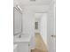 Bathroom with white vanity, sink, and marble countertop and hardwood floors at 6523 Clavell Ln, Charlotte, NC 28210