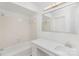 Bathroom with white tile, vanity with marble countertop and sink and hardwood floors at 6523 Clavell Ln, Charlotte, NC 28210