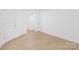 Bedroom with hardwood floors, white walls, and closet at 6523 Clavell Ln, Charlotte, NC 28210