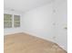This is a room with wood floors and a door and window with blinds at 6523 Clavell Ln, Charlotte, NC 28210