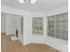 Bright breakfast nook with large windows, fireplace, and hardwood floors at 6523 Clavell Ln, Charlotte, NC 28210