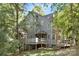 Charming two-story home with covered entryway, deck, and mature trees at 6523 Clavell Ln, Charlotte, NC 28210