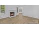 Bright living room featuring a fireplace and wood flooring, creating a warm and inviting space at 6523 Clavell Ln, Charlotte, NC 28210