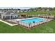 Community pool area with a slide, seating, landscaping, and a clubhouse in a new home development at 715 Olde England Dr, Lincolnton, NC 28092