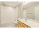 Bright bathroom features a wooden vanity, modern fixtures, and tiled shower-tub at 718 W Trade St # 708, Charlotte, NC 28202