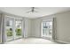 Bedroom with neutral carpet, large windows, and access to balcony at 718 W Trade St # 708, Charlotte, NC 28202