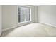 Well-lit bedroom with a large window and neutral carpet at 718 W Trade St # 708, Charlotte, NC 28202