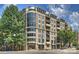 Modern condominium building with large windows, balconies, and street-level retail space at 718 W Trade St # 708, Charlotte, NC 28202