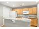 Bright kitchen featuring stainless steel appliances, light wood cabinets, and breakfast bar at 718 W Trade St # 708, Charlotte, NC 28202
