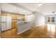 Bright kitchen featuring stainless steel appliances, light wood cabinets, and breakfast bar at 718 W Trade St # 708, Charlotte, NC 28202
