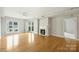 Bright living room with hardwood floors, fireplace, and access to a balcony at 718 W Trade St # 708, Charlotte, NC 28202