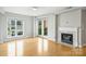 Bright living room with hardwood floors, fireplace, and access to a balcony at 718 W Trade St # 708, Charlotte, NC 28202