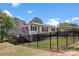 Exterior of the white home with a large deck and backyard fenced in for privacy at 8044 Eagle St, Mount Pleasant, NC 28124