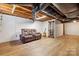 Finished basement with neutral flooring, comfortable seating, and cabinet for storage at 8044 Eagle St, Mount Pleasant, NC 28124