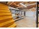 Unfinished basement space with wooden staircase, storage shelves, and exposed ceiling at 8044 Eagle St, Mount Pleasant, NC 28124