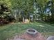 Large backyard with mature trees, a storage shed, a fire pit and plenty of green space at 8623 Cedar Hollow Ln, Huntersville, NC 28078