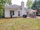Green backyard featuring a patio, grill, and well-maintained lawn, perfect for outdoor gatherings and relaxation at 8623 Cedar Hollow Ln, Huntersville, NC 28078