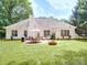Spacious backyard features a patio with dining set, fire pit, and lush green lawn, offering a serene outdoor space at 8623 Cedar Hollow Ln, Huntersville, NC 28078