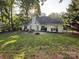Expansive backyard featuring a patio, a fire pit, and tall trees creating a private oasis at 8623 Cedar Hollow Ln, Huntersville, NC 28078