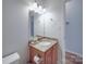 Bathroom featuring a granite countertop vanity, mirror, lighting, and a doorway leading to the toilet at 8623 Cedar Hollow Ln, Huntersville, NC 28078