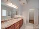 Bathroom with double vanity with granite counters, a separate shower, and an adjacent walk-in closet at 8623 Cedar Hollow Ln, Huntersville, NC 28078