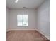 Spacious bedroom with natural light, neutral walls, and plush carpet, creating a comfortable and inviting space at 8623 Cedar Hollow Ln, Huntersville, NC 28078