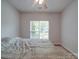 Well-lit bedroom with a queen-size bed, ceiling fan, and window, creating a peaceful and inviting atmosphere at 8623 Cedar Hollow Ln, Huntersville, NC 28078
