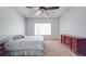 Bedroom boasts neutral carpet, a tray ceiling, a window, and a decorative dresser at 8623 Cedar Hollow Ln, Huntersville, NC 28078