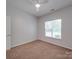 Inviting bedroom with carpet flooring, a ceiling fan, and window with lots of natural light at 8623 Cedar Hollow Ln, Huntersville, NC 28078
